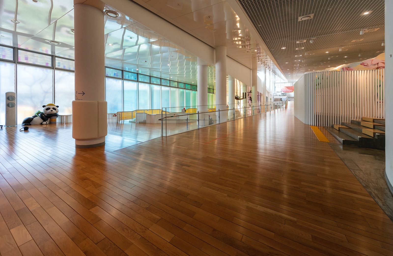 a large room with wooden floors and large windows