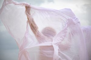 a woman is wrapped in a white sheet